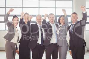 Businessman cheering with clenched fist