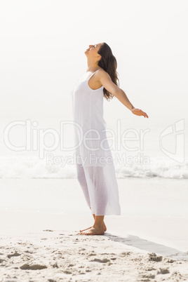 Beautiful woman stretching on the beach