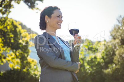 Pretty businesswoman having a glass of wine