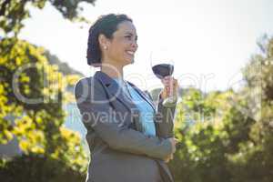 Pretty businesswoman having a glass of wine