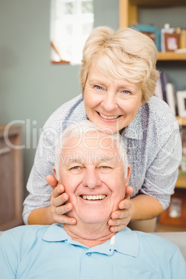 Portrait of senior woman holding her husband