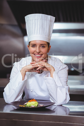 Chef leaning on the counter with a dish