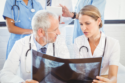 Two doctors examining an x-ray report