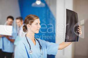 Female doctors examining X-ray