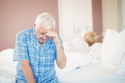 Tensed senior couple at home