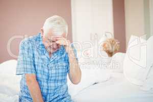 Tensed senior couple at home