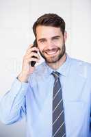 Happy businessman talking on cellphone