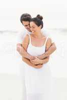 Happy couple embracing on the beach