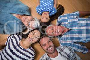Happy family lying on floor