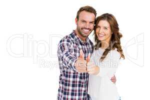 Happy young couple putting thumbs up