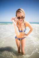 Portrait of happy woman standing on the beach