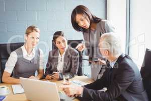 Businesspeople interacting in conference room