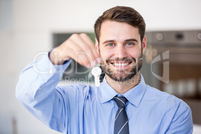 Happy businessman showing house keys