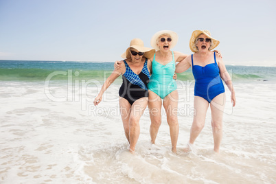 Senior woman friends playing in water