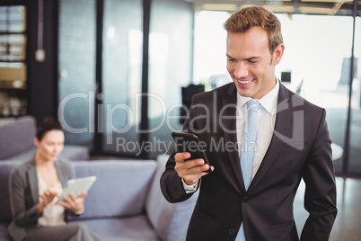 Businessman looking at mobile phone Businessman looking at mobile phone