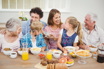 Cheerful multi-generation family having breakfast