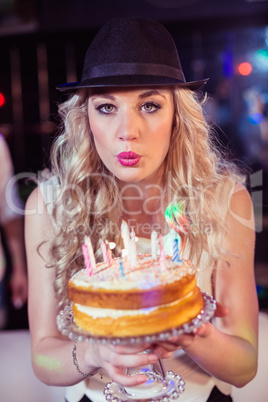 Woman blowing out candles