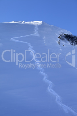 Trace from ski on off-piste slope in early morning