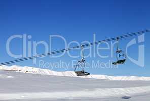 Chair-lift and blue clear sky at sun day