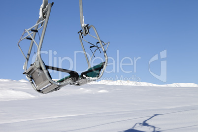 Chair-lift in ski resort at sun day after snowfall