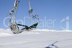 Chair-lift in ski resort at sun day after snowfall