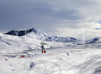 Ski slope with surface lift and gray sky