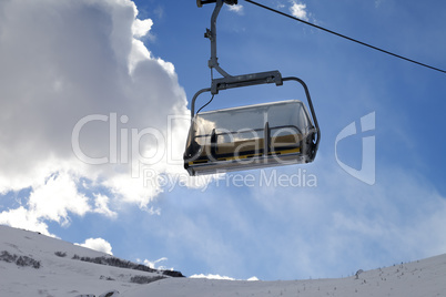 Chair-lift in ski resort at sun evening
