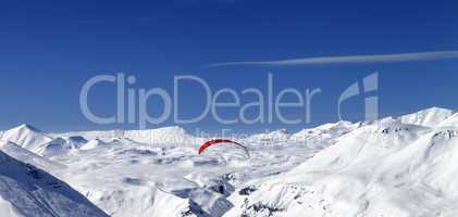Panoramic view on sky gliding in snowy mountains