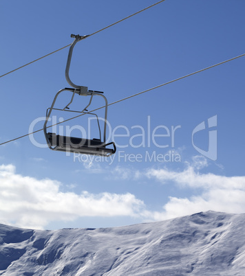 Chair lift and snowy mountains at nice day