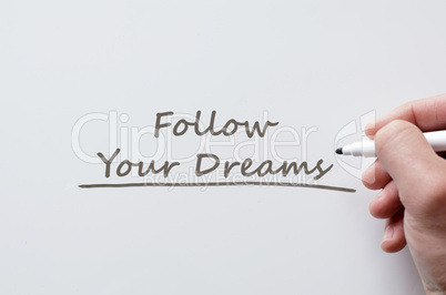 Follow your dreams written on whiteboard