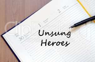 Unsung heroes write on notebook