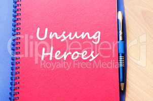 Unsung heroes write on notebook