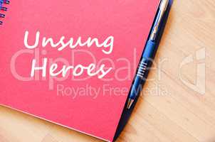 Unsung heroes write on notebook