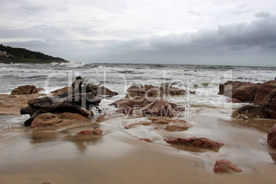 Stormy Beachfront with Wood Stump