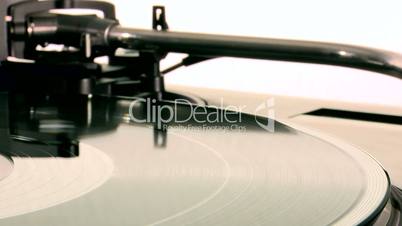 DJ Turntable. Dropping the needle on a spinning vinyl record player and take it back.