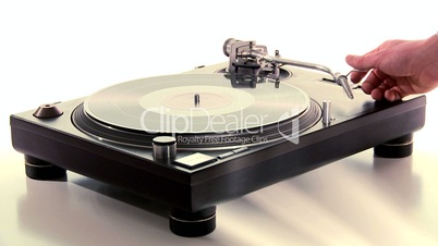 DJ Turntable. Dropping the needle on a spinning vinyl record player.