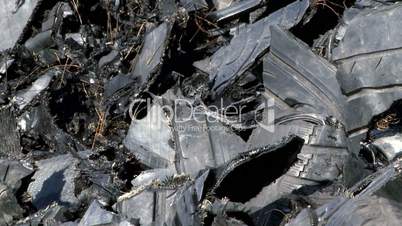 Shredded car tires pile for recycling. Close-up, tilt.