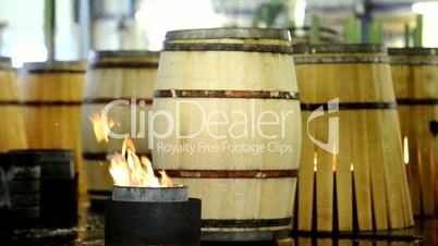 Fireplace in front of wood barrels for wine barrel production.