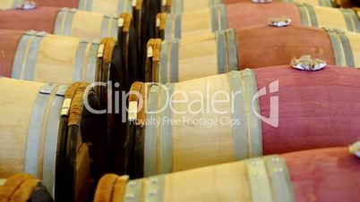 Vertical pan on wood barrels in a wine cellar in Bordeaux, France.