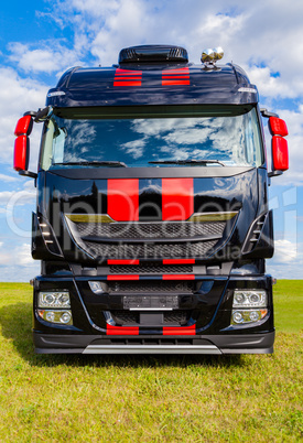 red striped big rig on grass