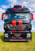 red striped big rig on grass