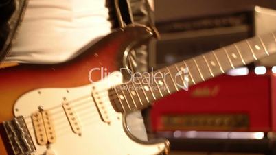 Guitarist. Close-up on a male hand starting playing electric guitar.
