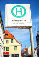 german bus stop sign in a city on Amtsgericht - nur zum Ausstieg - sign means - district court - only get out