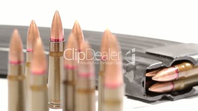 AK-47 ammunition. Defocus on a bunch of upright bullets. From the rearmost to the foremost.