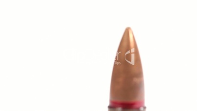 AK-47 ammunition. Tilt and defocus on a single upright bullet head. White background.