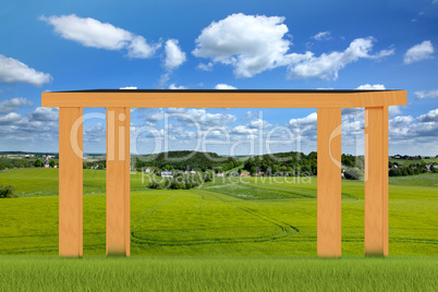 Massive wooden table stands in the meadow