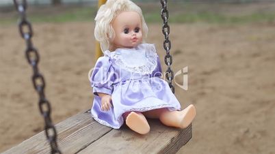 Doll on a swing