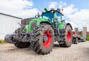 german green tractor with low bed trailer