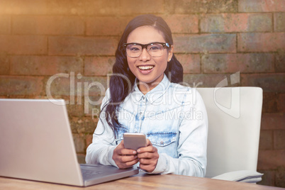 Young thoughtful businessman standing in office