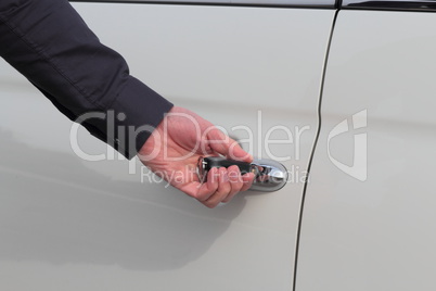 Male hand open white car with key